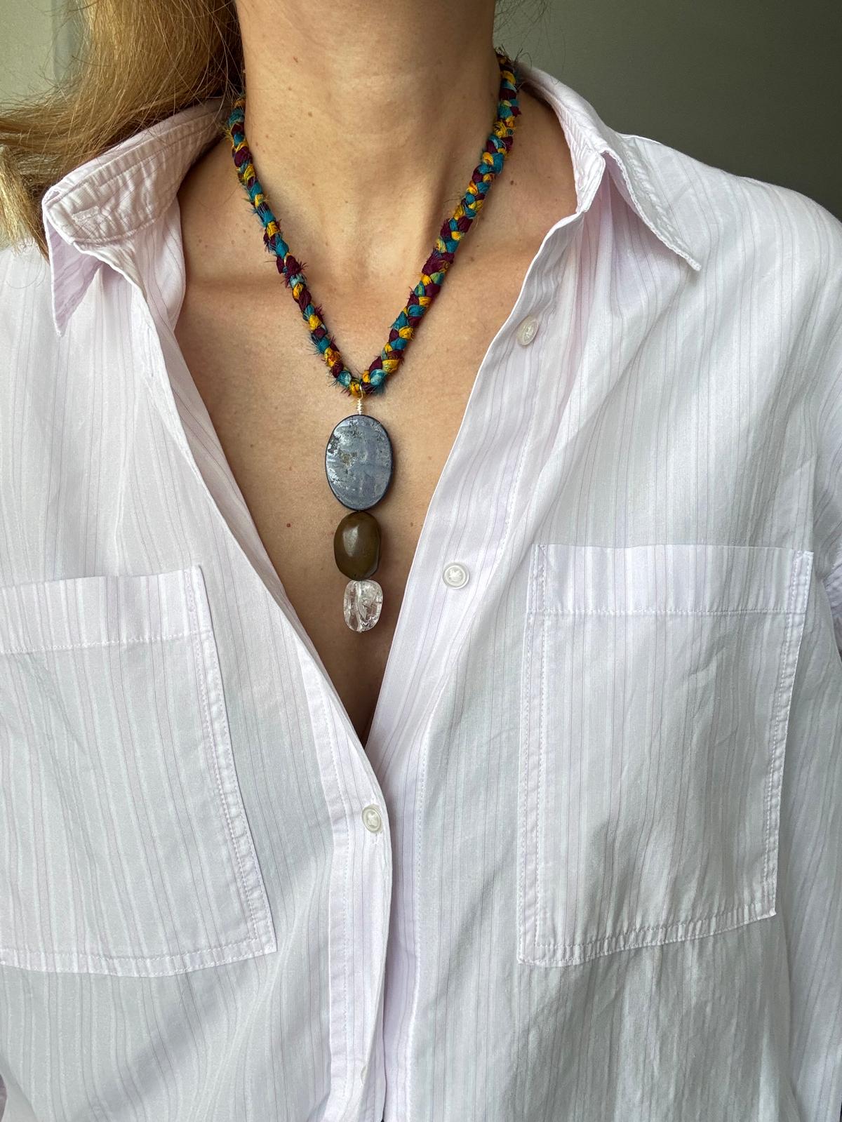 Full view of the necklace being worn, showing how the braided cord sits and the pendant drops