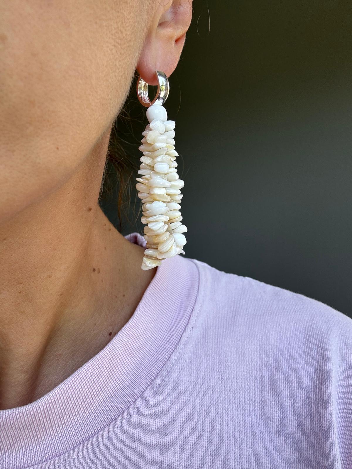 Close view of the tassel, showing the massed cream and ivory shell chips and the polished silver hoop
