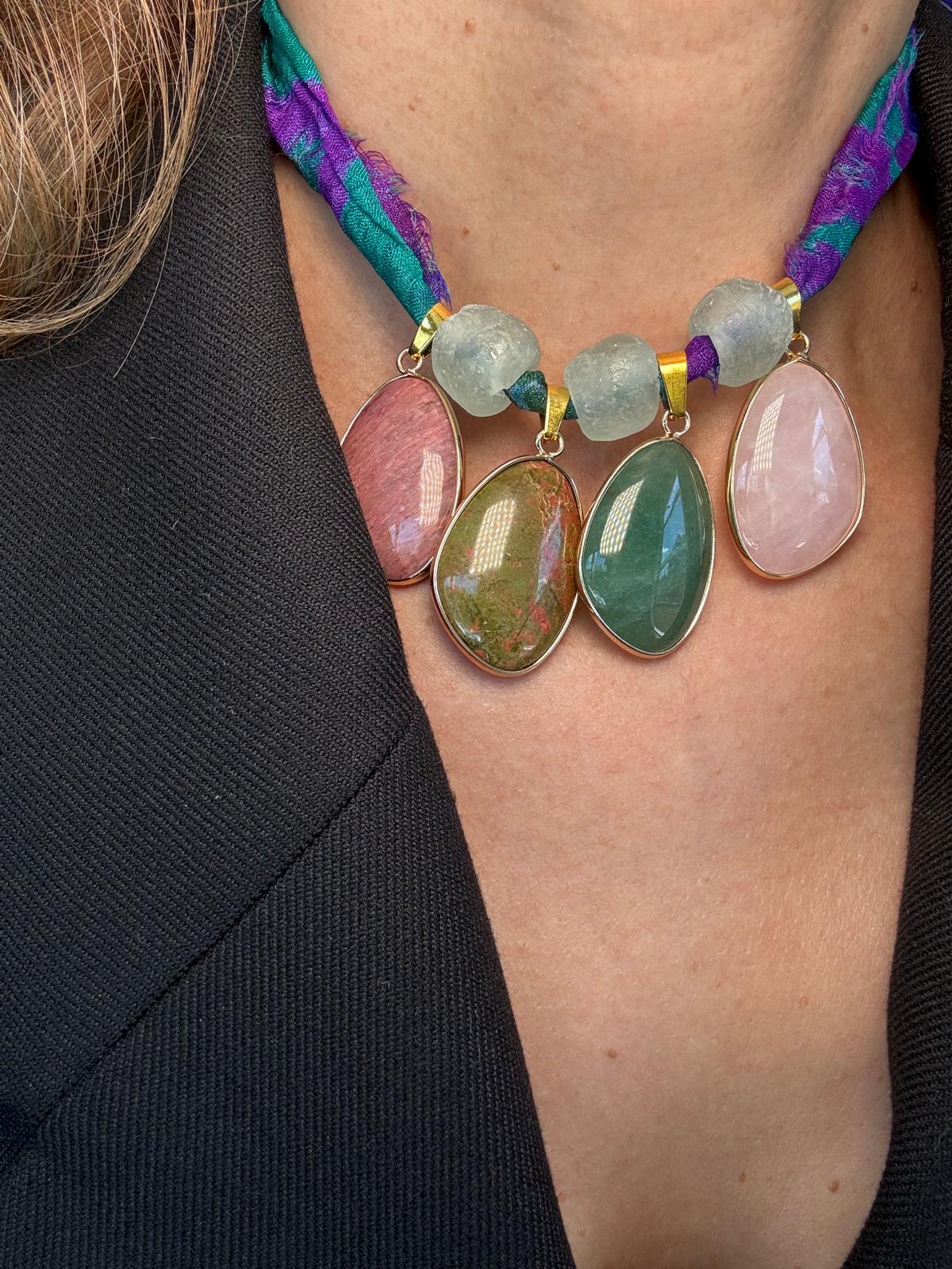 The necklace worn, showing how the stones sit against an open collar