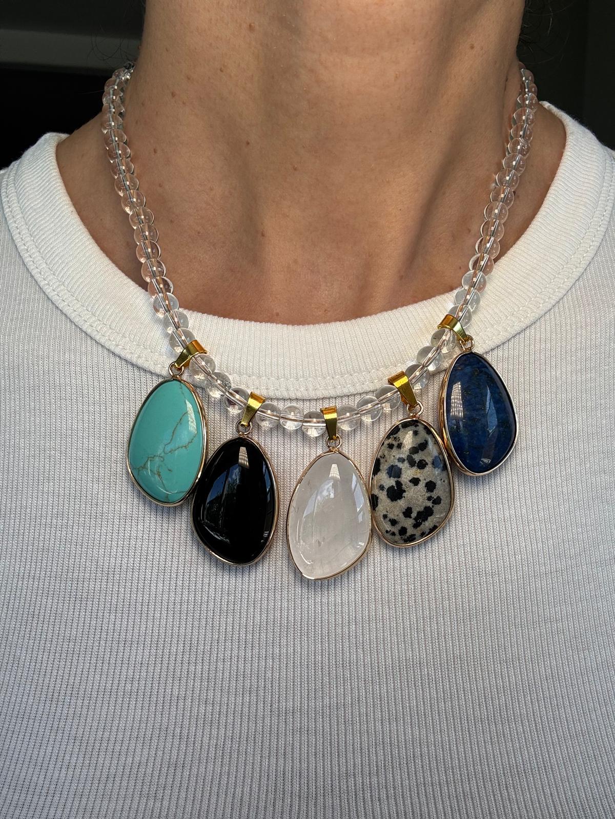 Detail of the worn necklace, the spotted dalmatian jasper and deep blue lapis lazuli in daylight
