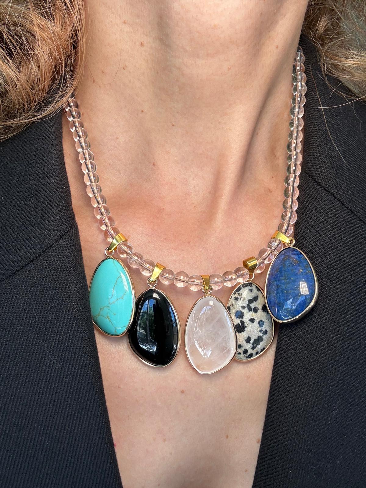 Close view of the clear quartz bead strand and the gold bails joining the stones