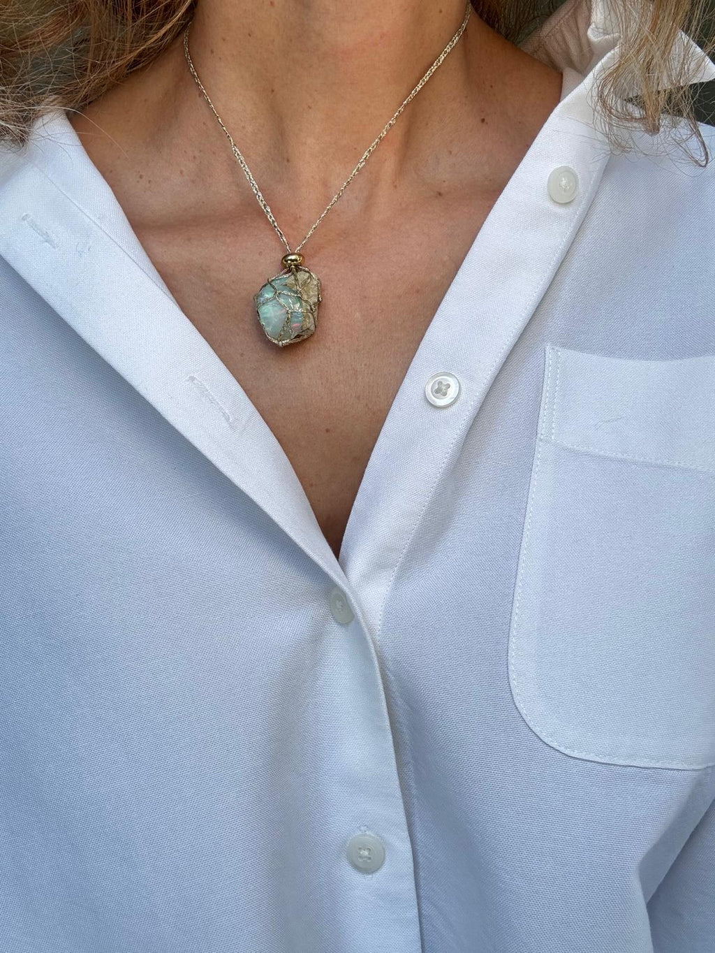 Raw opal pendant necklace worn, braided cord at the neck