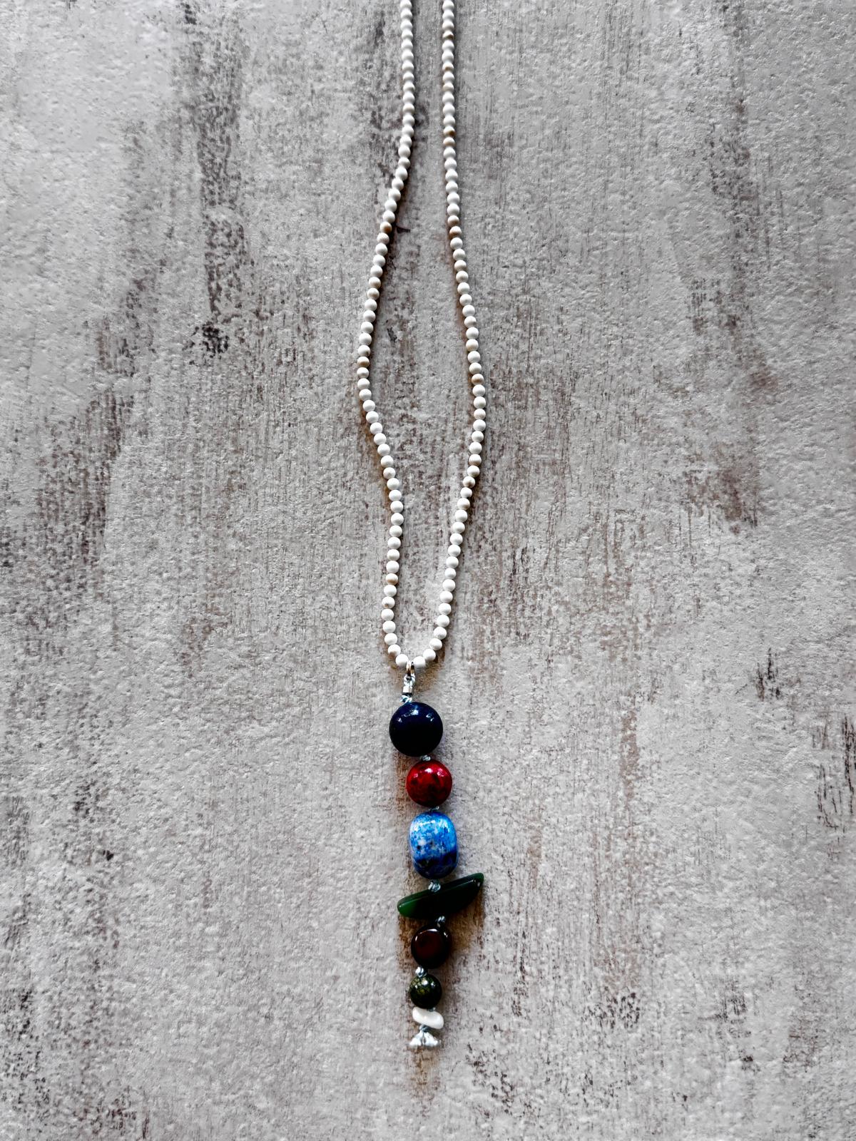 Close view of the drop — lapis lazuli, coral, kyanite, green jasper, tiger's eye, chrysoprase and mother of pearl stacked in a column
