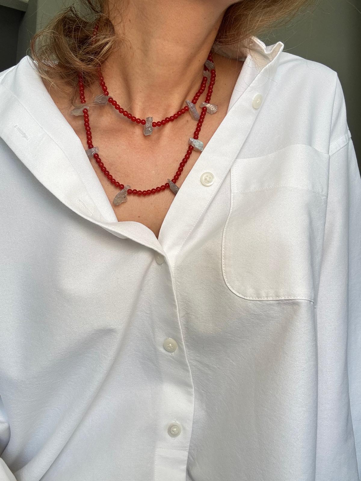 Close view of the doubled necklace showing the unpolished faces of the labradorite against the red beads