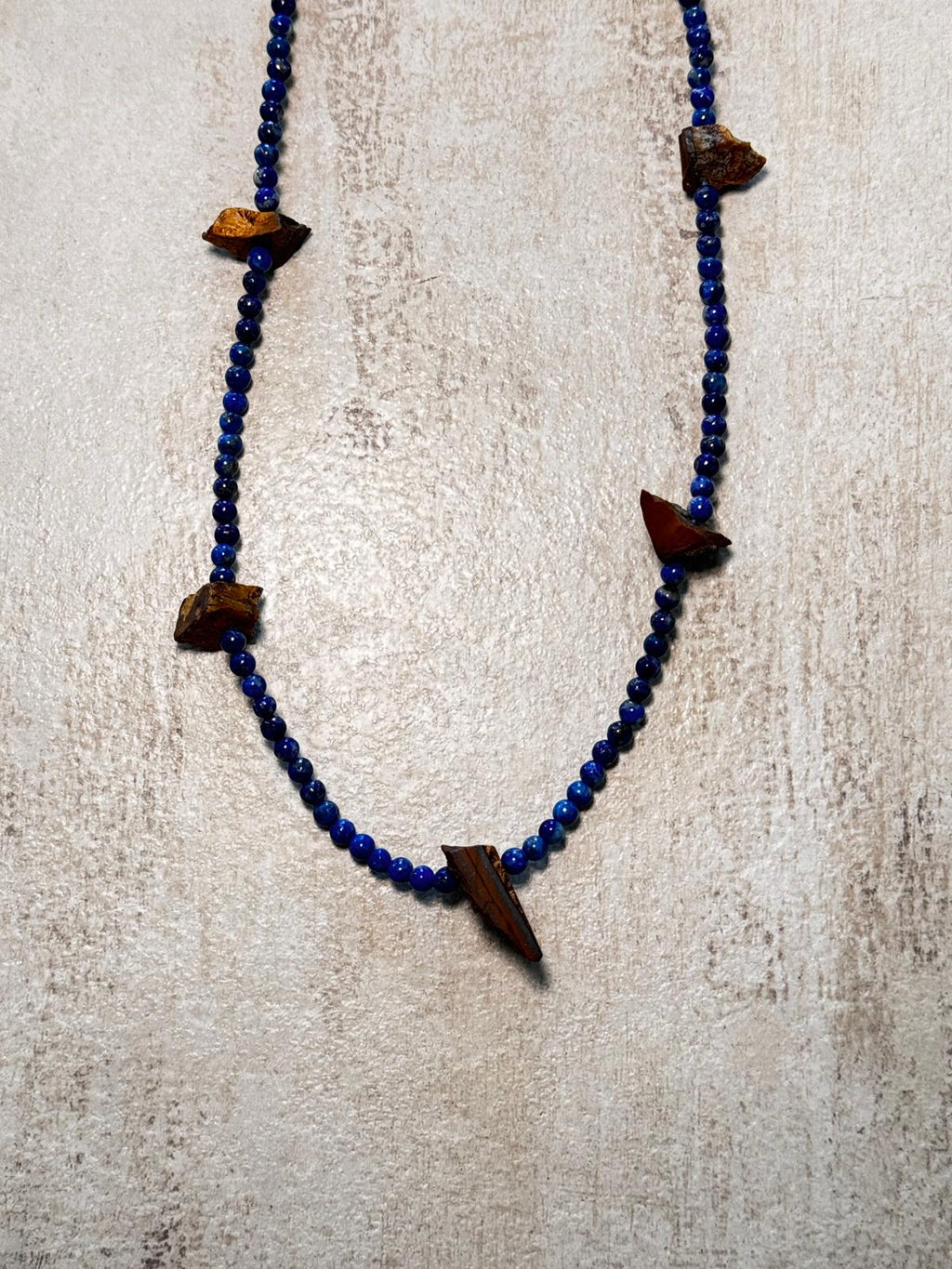 Close view of the deep blue lapis beads and the unpolished golden-brown tiger's eye chunks