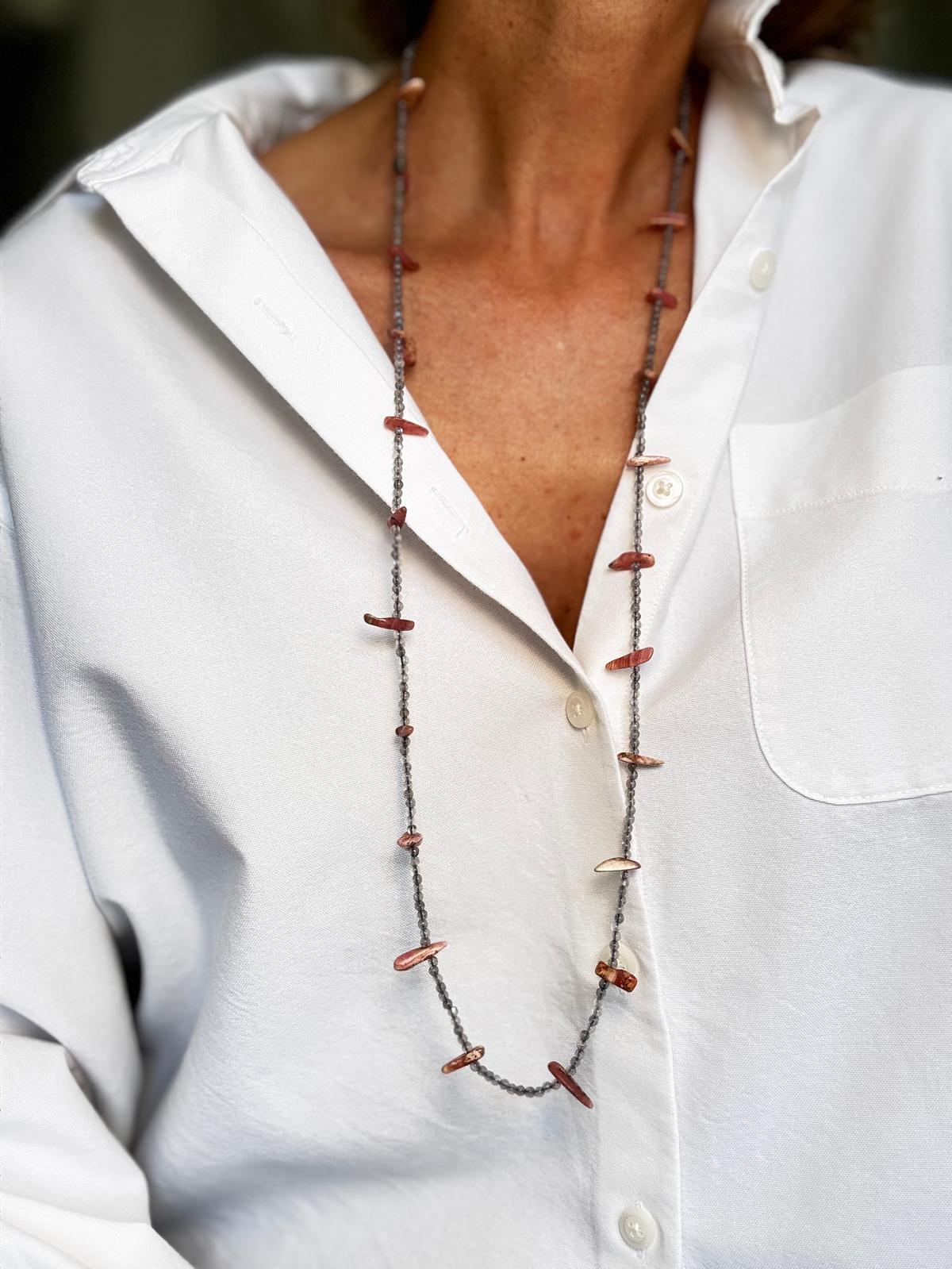 The necklace worn long, the rhodochrosite points standing out from the strand