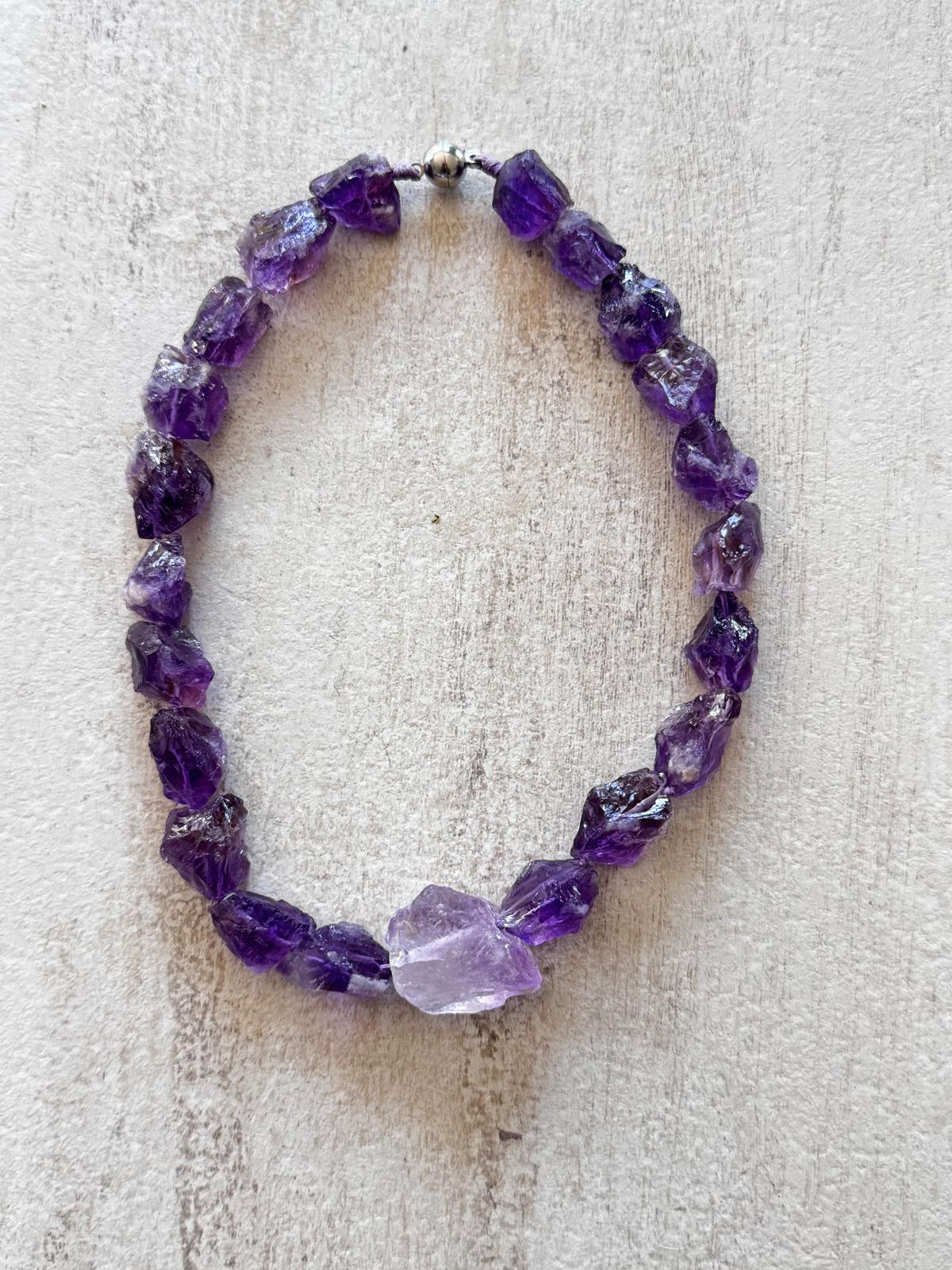 The full necklace laid flat, every amethyst a different broken shape
