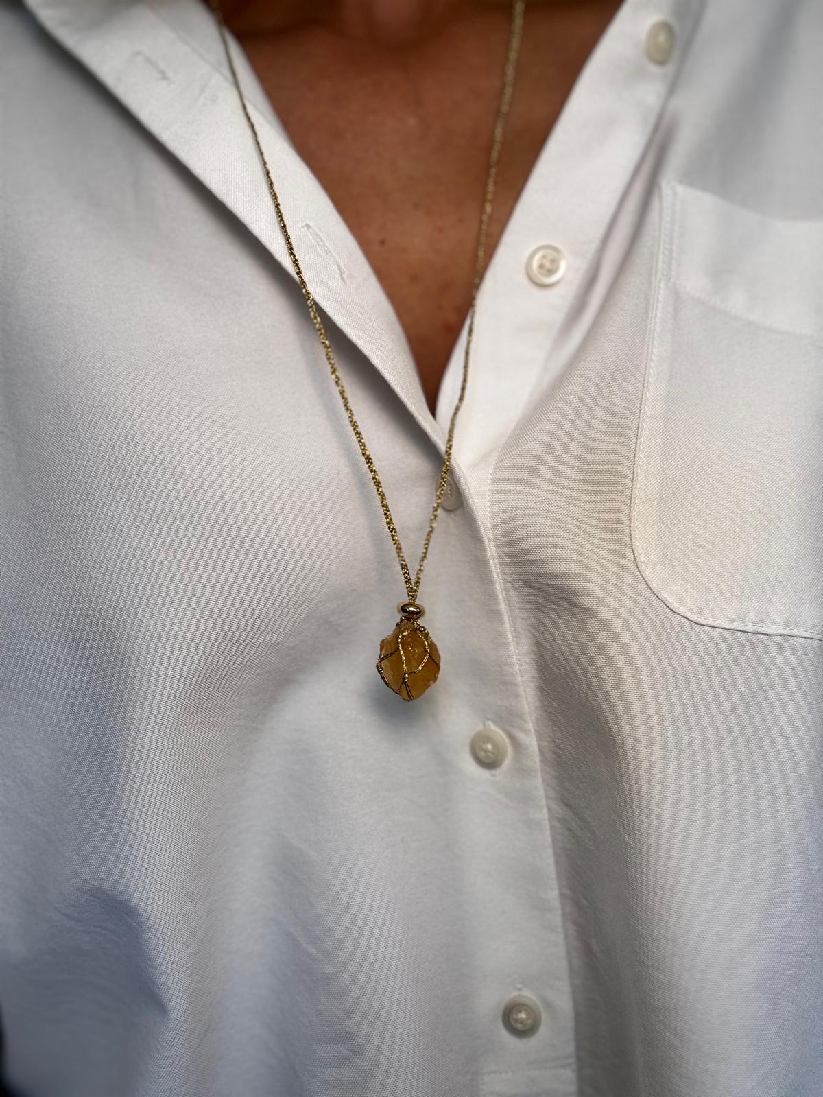 Close view of the citrine, warm amber through the braid, with the gold-plated spacer above