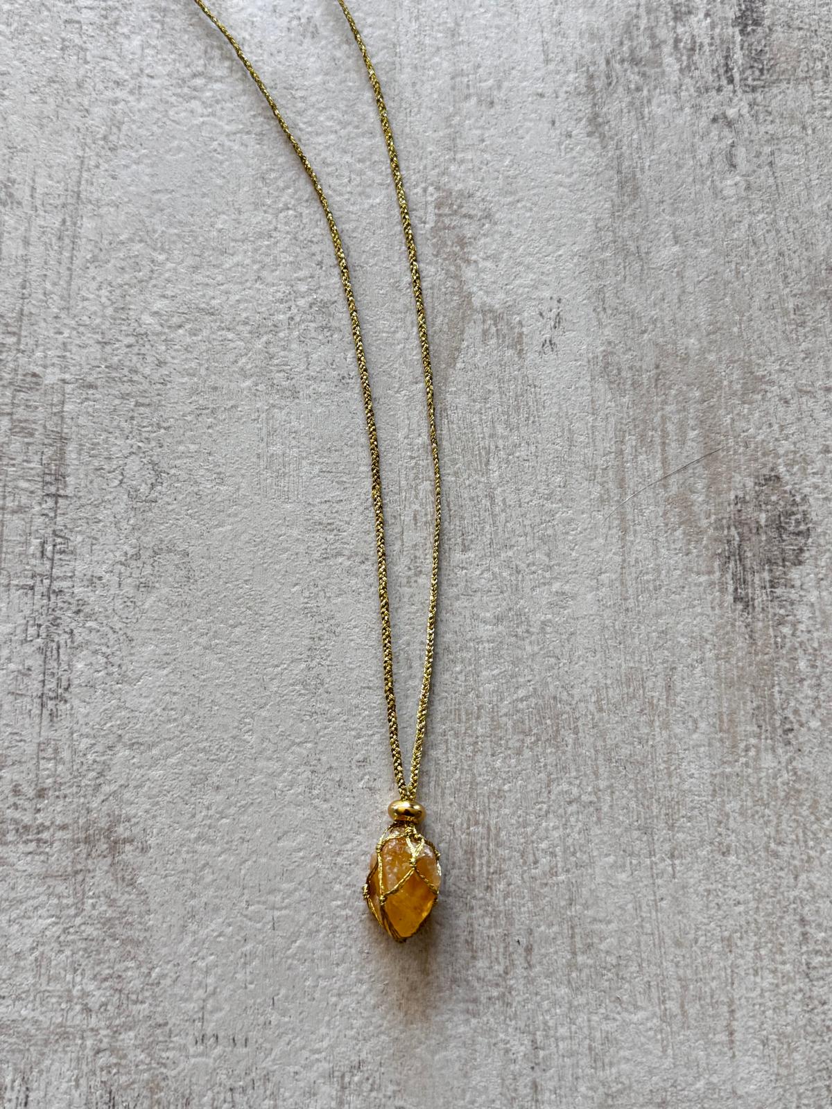 Close view of the raw citrine caught in the golden braid