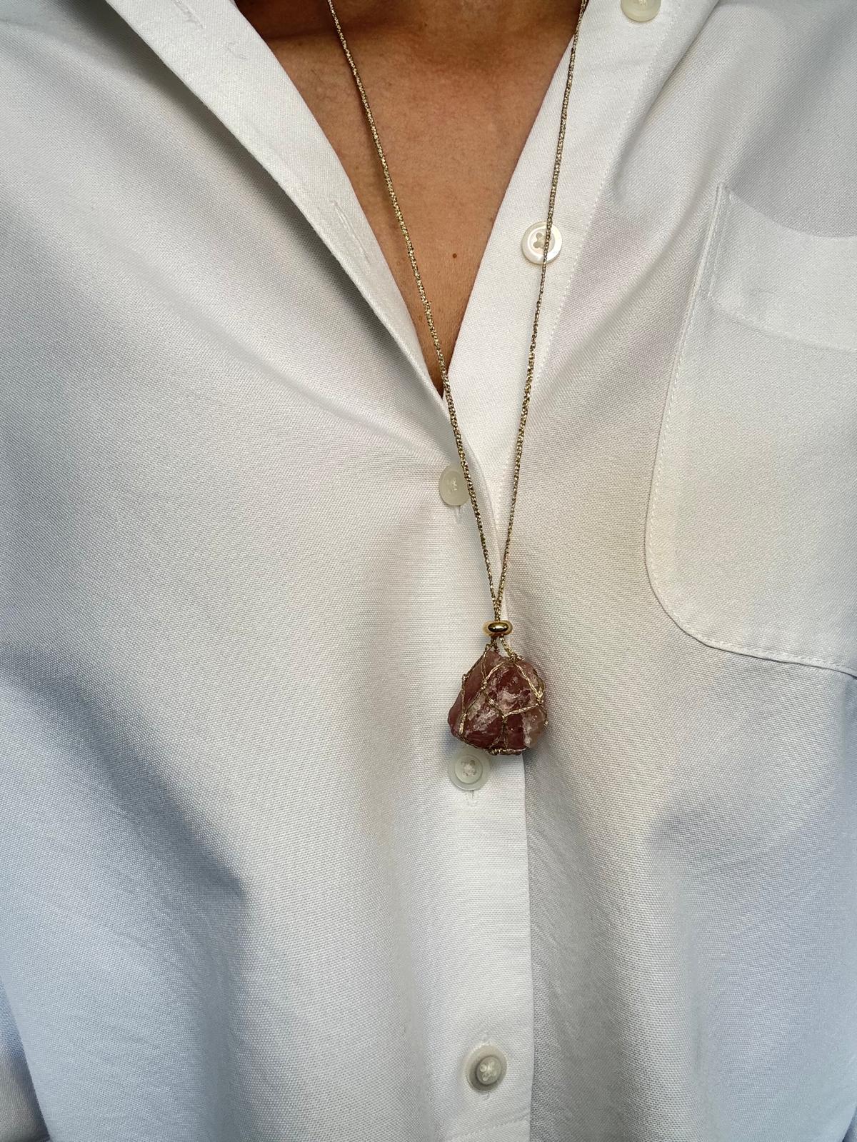 The pendant worn longer on the sliding braided cord, hanging at mid-chest