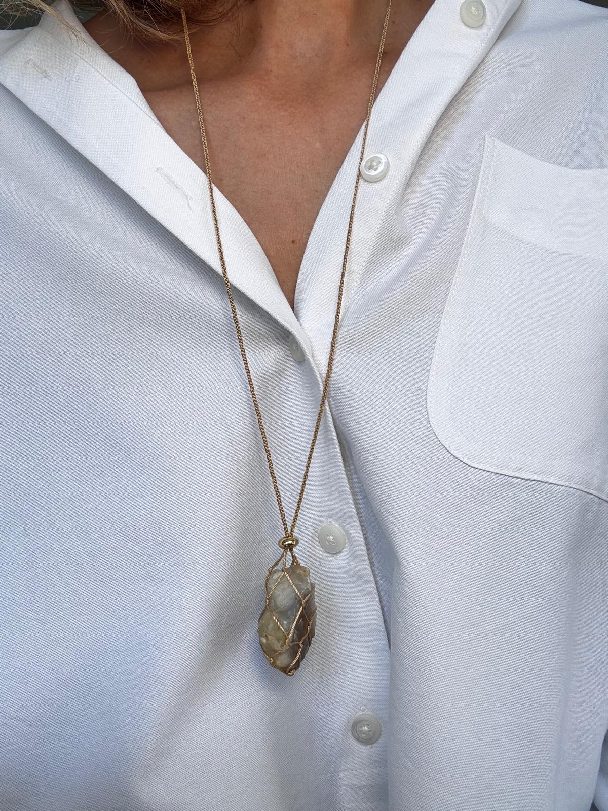 The pendant worn at its longest setting, showing the full drop of the silk cord