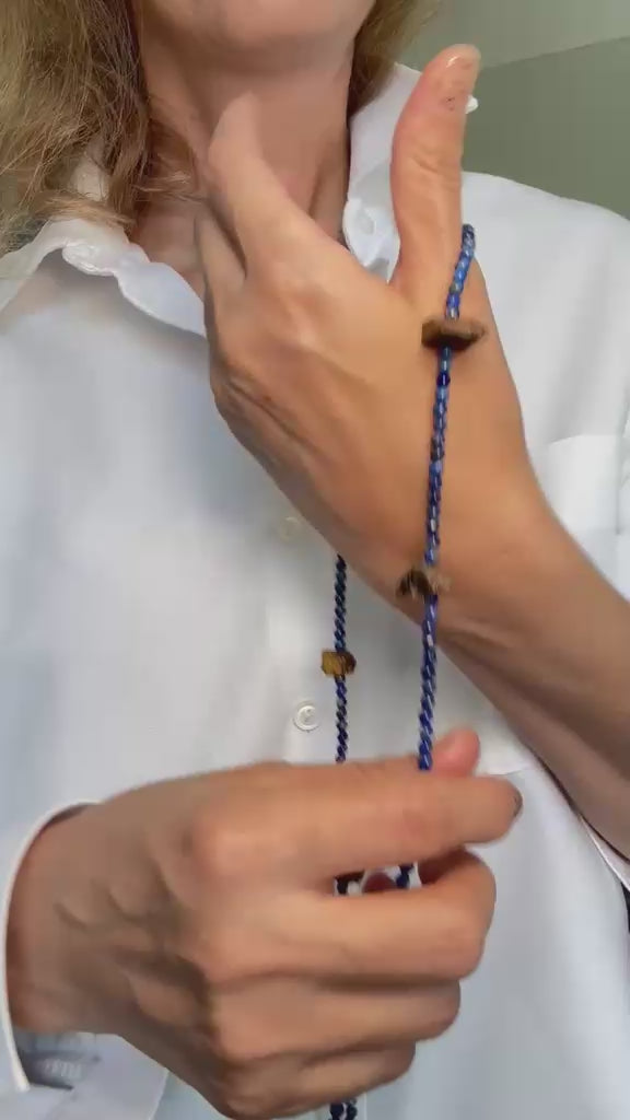 Video of the necklace worn as a wrap bracelet, showing how the lapis strand winds around the wrist