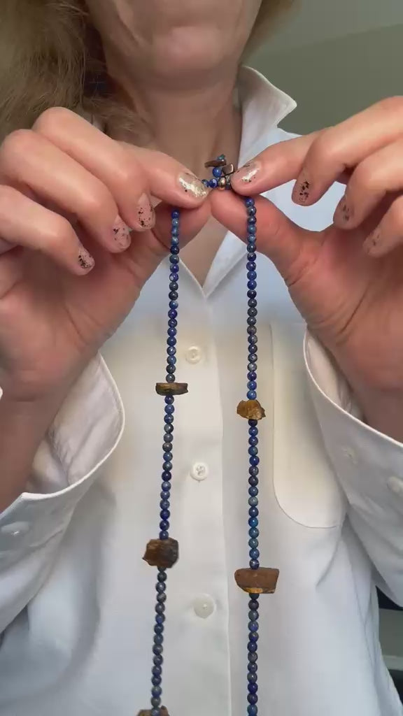 Video of the lapis lazuli and rough tiger's eye necklace moving, showing the full length and the raw stone faces