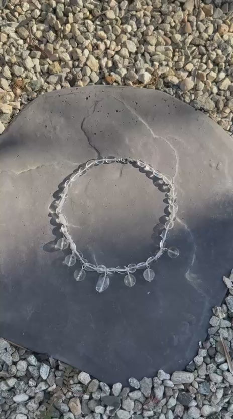 Video of the clear quartz necklace moving in the light, showing how the drops swing and flash