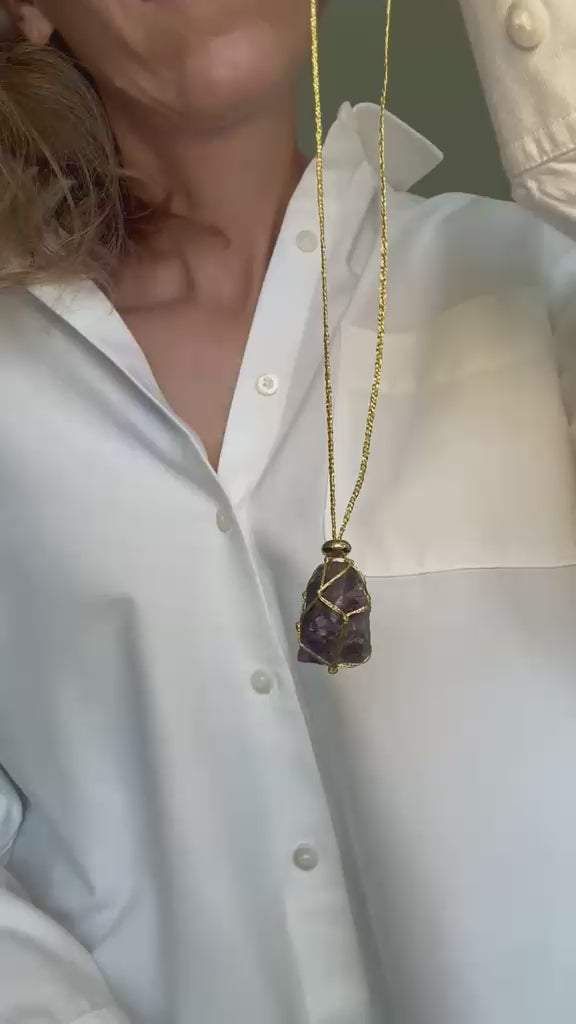 Video of the raw amethyst pendant turning on its braided gold cord