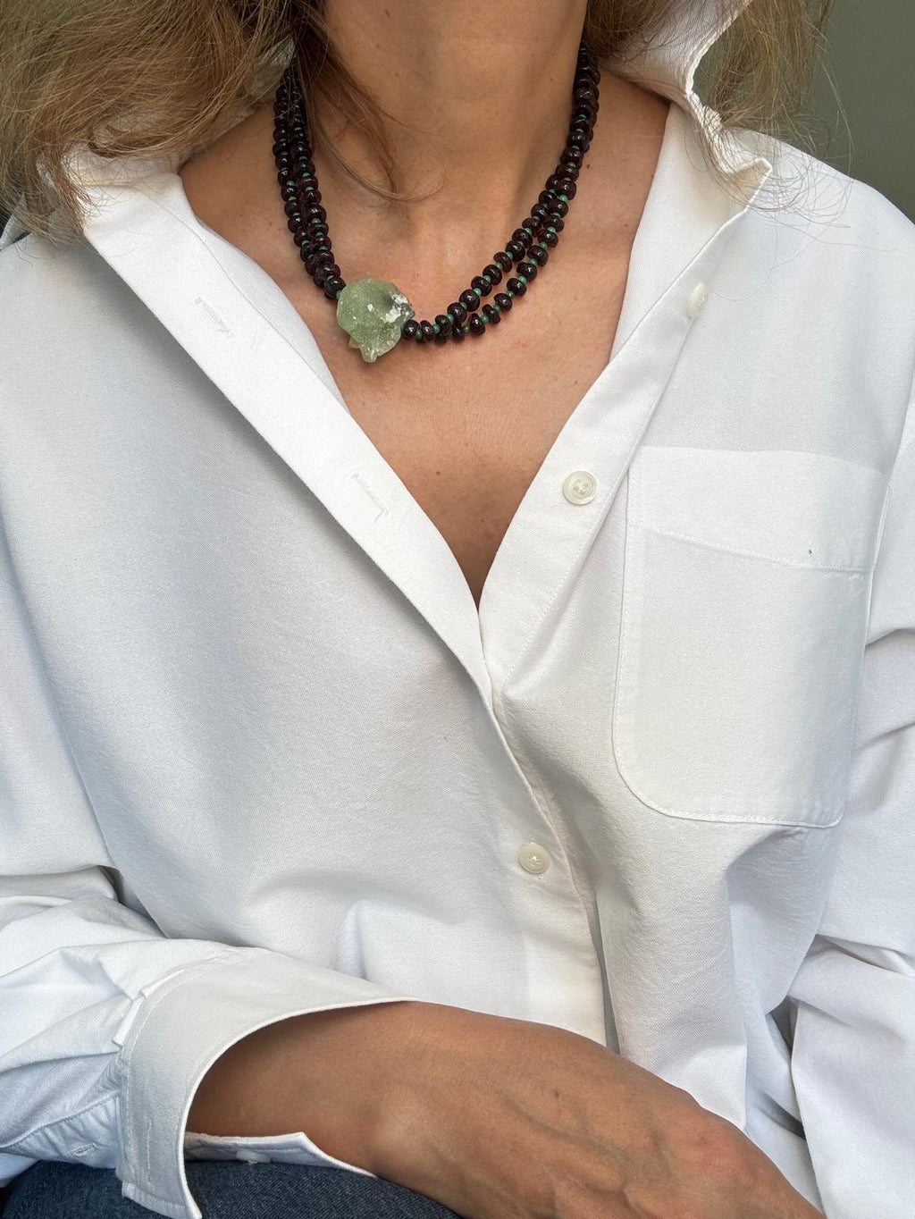 The garnet necklace worn doubled as a two-strand choker, the raw prehnite nugget sitting at the centre