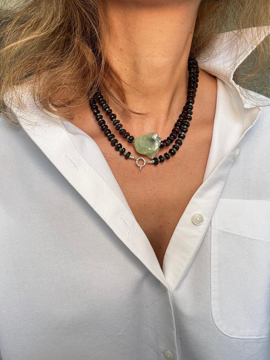 Close view of the doubled necklace showing the sterling silver snap hook clasp worn at the front beneath the prehnite
