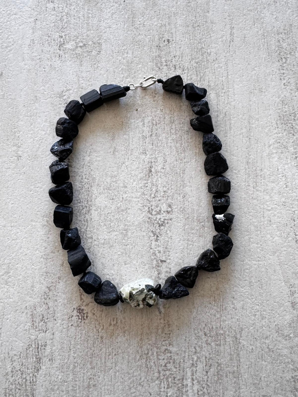 The full necklace laid flat, every tourmaline chunk a different broken shape