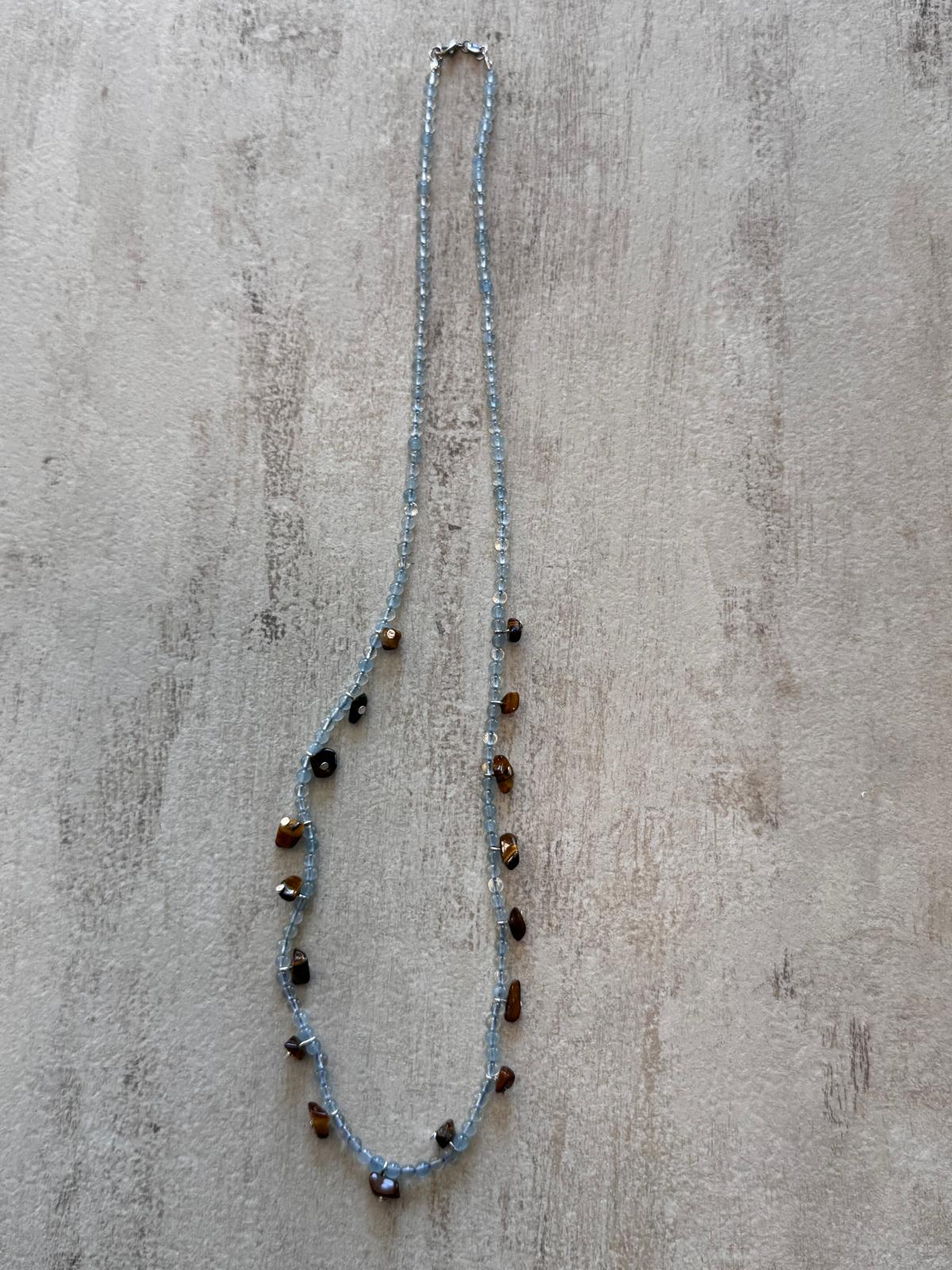 The full length of the necklace laid flat with the sterling silver lobster clasp at the top