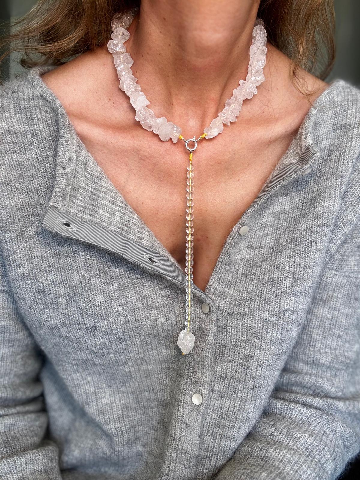 The raw clear quartz collar worn with the drop attached, hanging down the centre of the chest