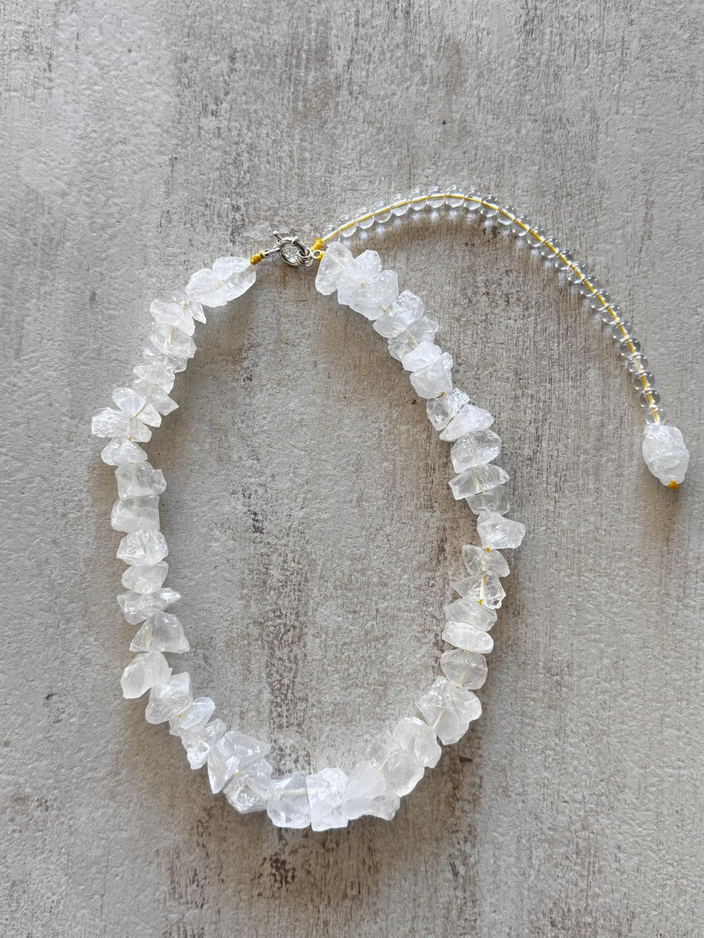The full necklace laid flat with the sterling snap hook clasp at the top