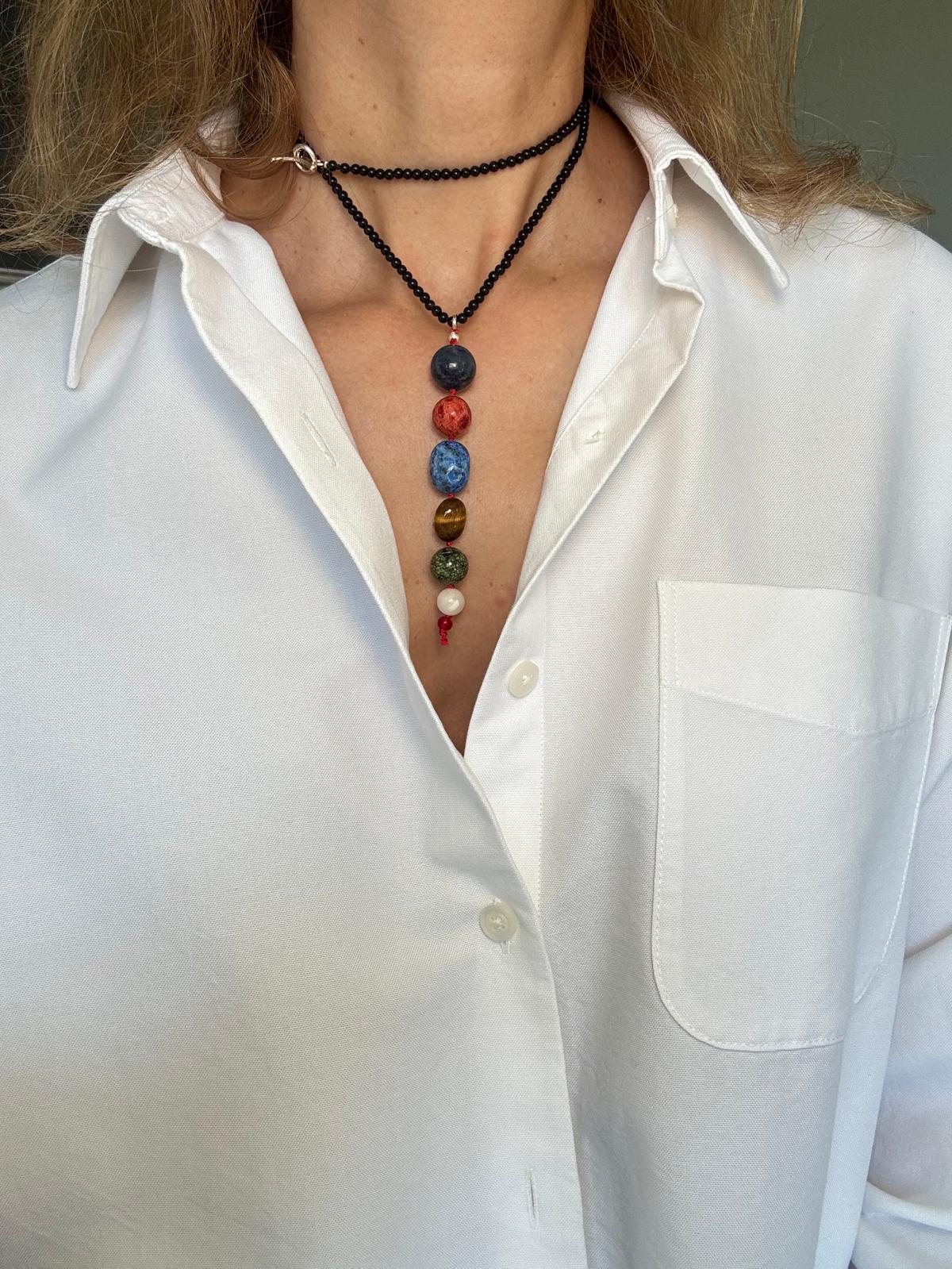 The same necklace worn doubled so the stone column sits high on the chest, sterling toggle at the collar